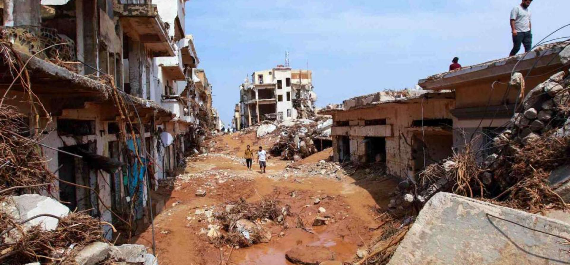 people-check-an-area-damaged-by-flash-floods-in-derna-eastern-libya-on-september-11-2023.jpg